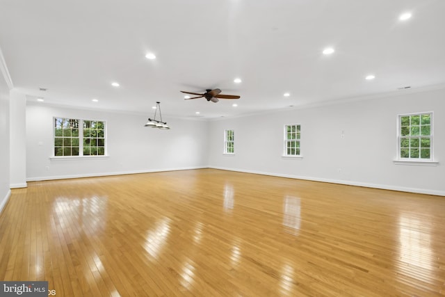 unfurnished living room featuring ceiling fan, crown molding, and light hardwood / wood-style floors