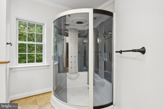 bathroom with tile patterned flooring, ornamental molding, a stall shower, and baseboards