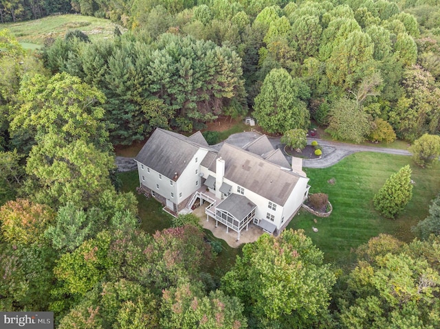 birds eye view of property with a view of trees