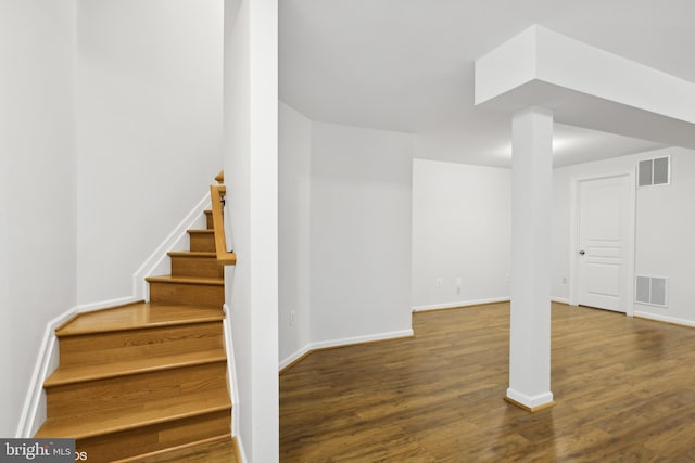 staircase with wood-type flooring