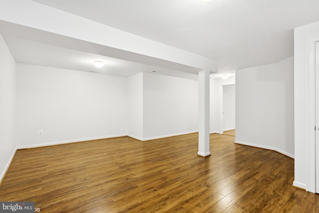 basement featuring dark hardwood / wood-style flooring