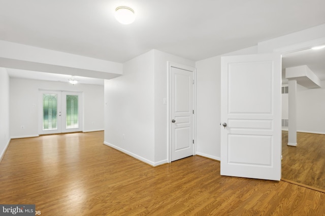 unfurnished room with baseboards and wood finished floors
