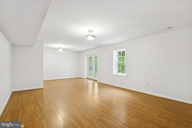 unfurnished room with hardwood / wood-style flooring