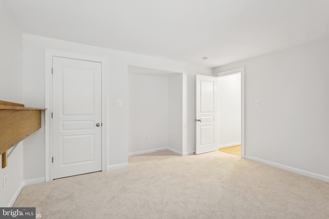 unfurnished bedroom with light colored carpet