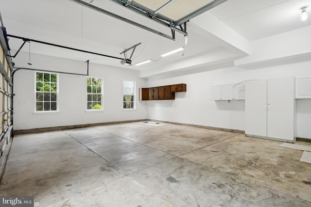 garage featuring baseboards and a garage door opener