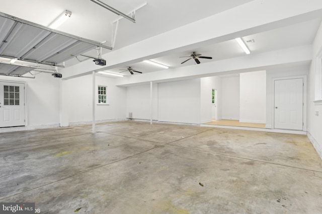 garage with a garage door opener and ceiling fan