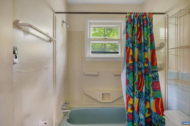 bathroom with shower / bath combination with curtain and toilet