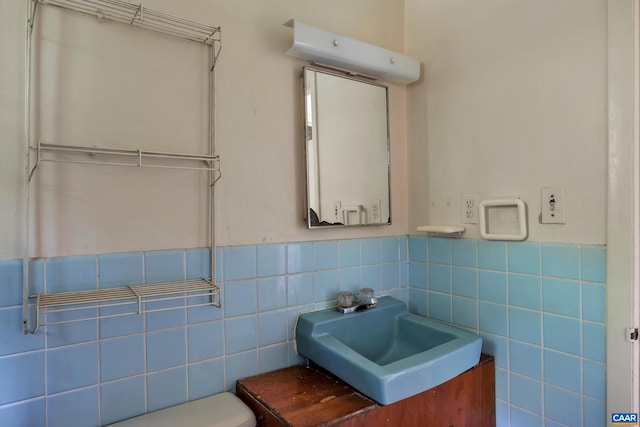 bathroom with vanity, tile walls, and toilet