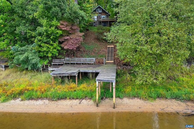 birds eye view of property featuring a water view and a beach view