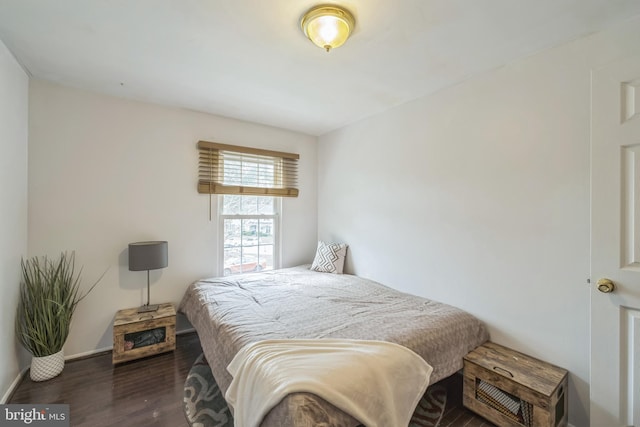 bedroom with dark hardwood / wood-style flooring