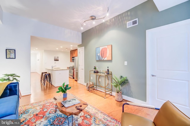 living room featuring light hardwood / wood-style floors and track lighting