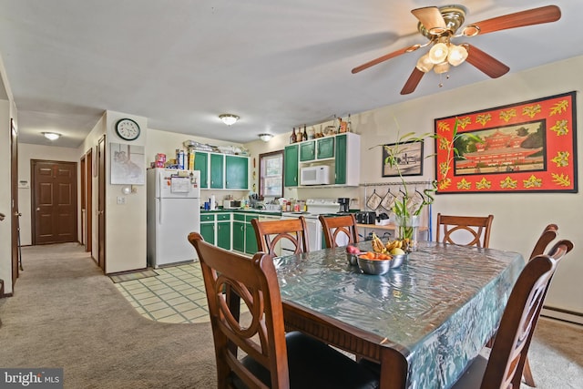 dining space featuring ceiling fan and light colored carpet