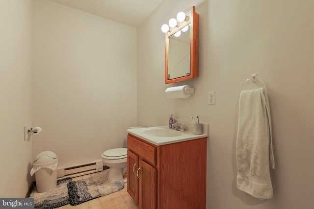 bathroom with toilet, vanity, and baseboard heating