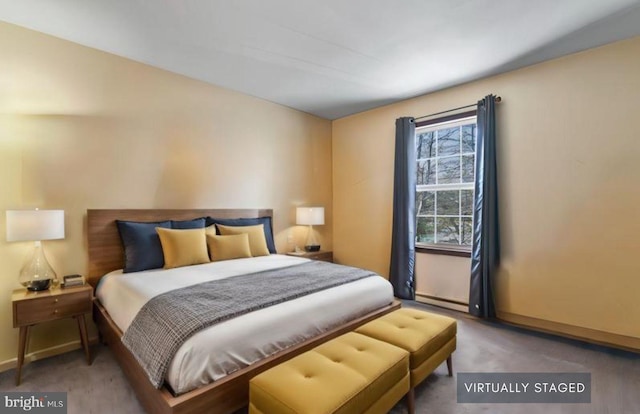 bedroom with a baseboard radiator and carpet