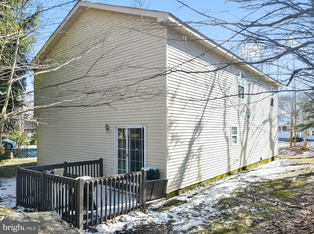 view of snow covered back of property