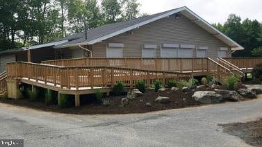 rear view of house with a wooden deck