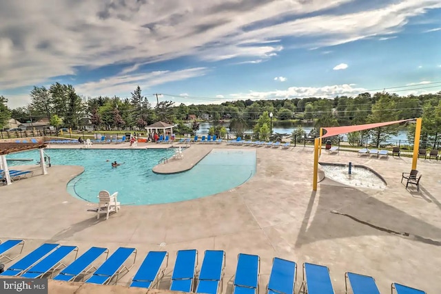 view of pool with a patio and a water view