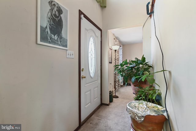 foyer featuring light carpet