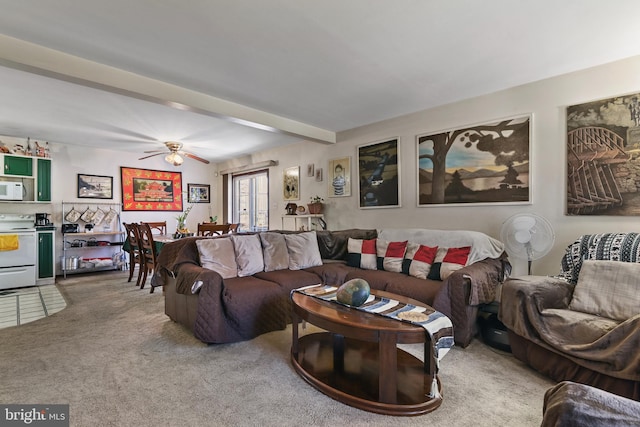 living room with beam ceiling, ceiling fan, and carpet flooring