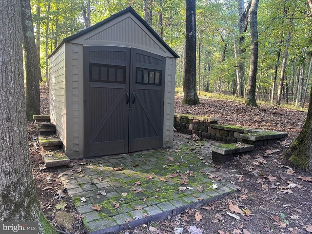 view of shed featuring a forest view