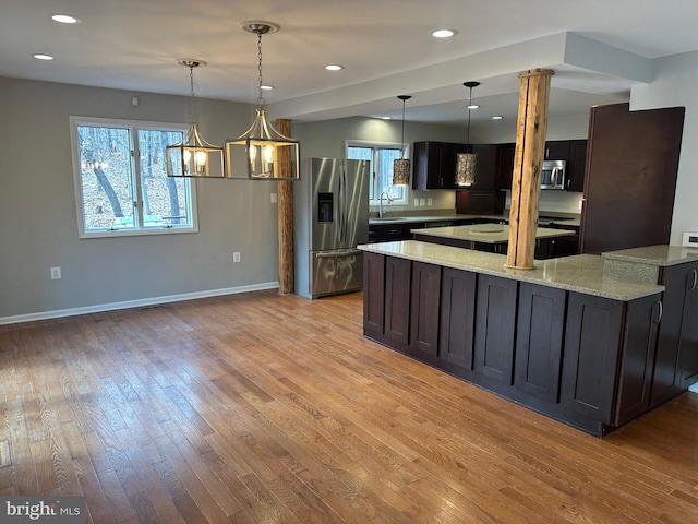 206 Mustang Ct, Gambrills, MD 21054 - kitchen with light wood-type flooring, baseboards, appliances with stainless steel finishes, and plenty of natural light