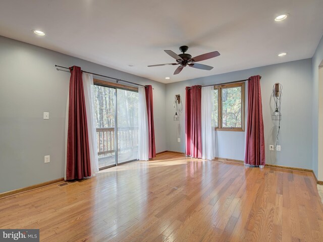 unfurnished room with plenty of natural light, recessed lighting, baseboards, and light wood-style floors