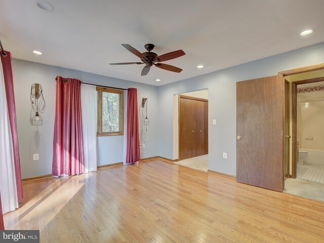 interior space with light wood finished floors, recessed lighting, a ceiling fan, and baseboards