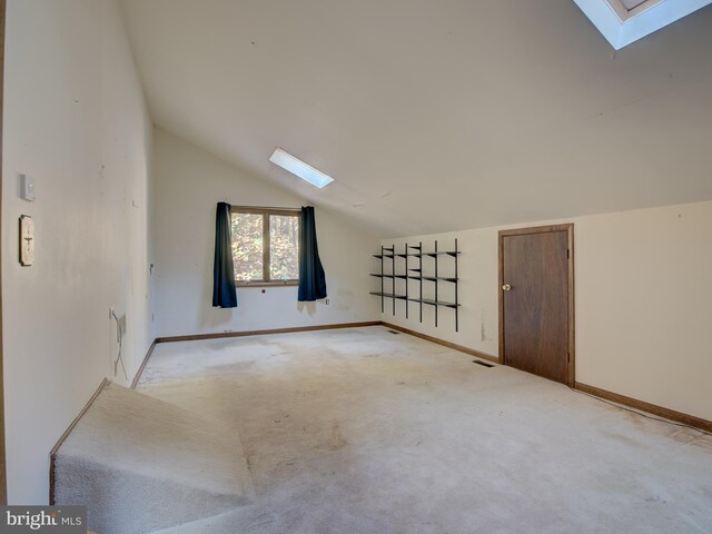 bonus room featuring baseboards, lofted ceiling with skylight, light colored carpet, and visible vents