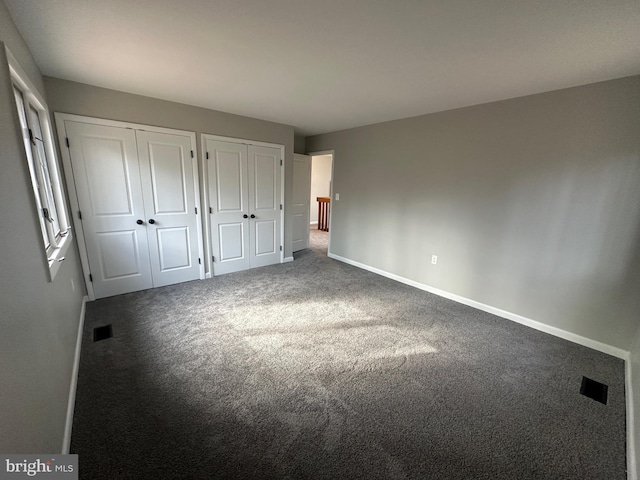 206 Mustang Ct, Gambrills, MD 21054 - unfurnished bedroom with baseboards, carpet flooring, multiple closets, and visible vents