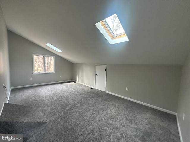 206 Mustang Ct, Gambrills, MD 21054 - additional living space featuring baseboards, vaulted ceiling with skylight, and dark carpet