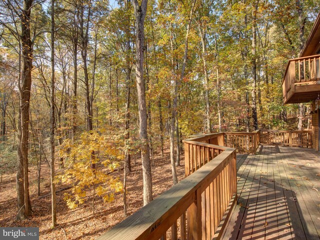 wooden deck with a view of trees