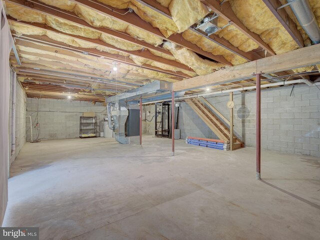 unfinished basement featuring heating unit