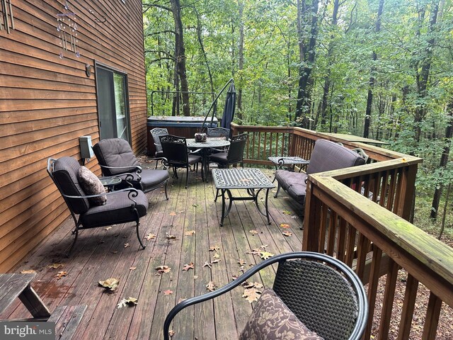 wooden deck featuring a forest view