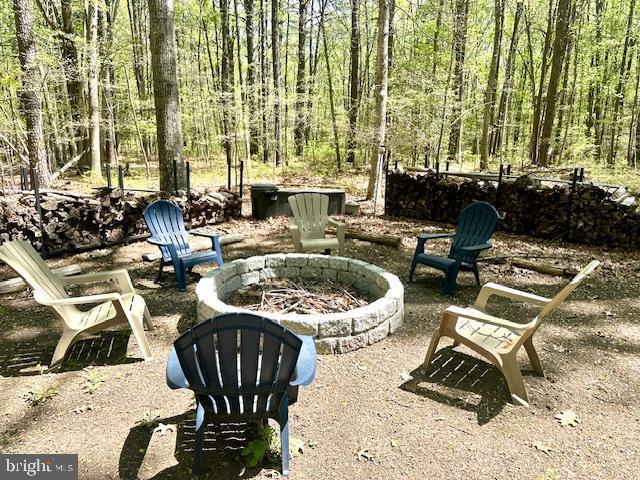 206 Mustang Ct, Gambrills, MD 21054 - view of patio / terrace featuring a forest view and a fire pit