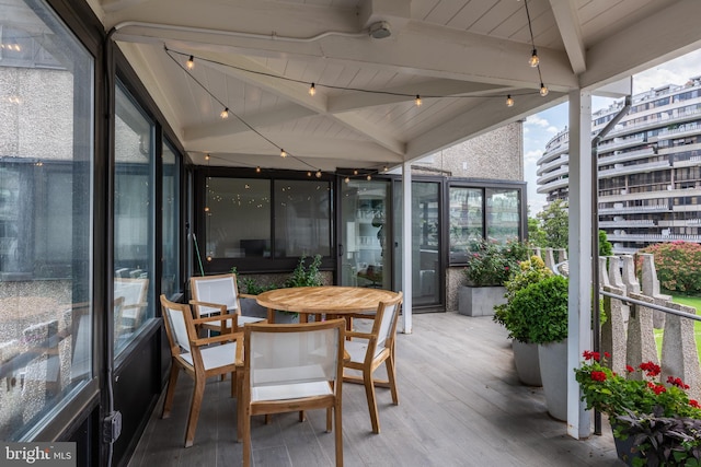 sunroom / solarium with wood ceiling and vaulted ceiling with beams