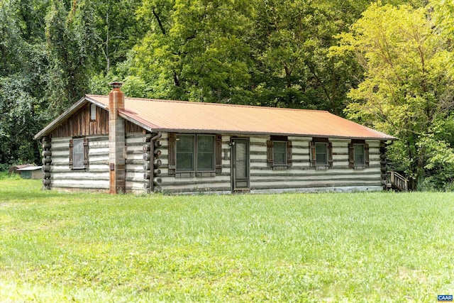 log-style house with a front yard