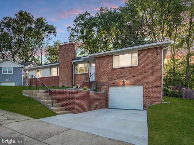 view of front of property with a garage and a yard