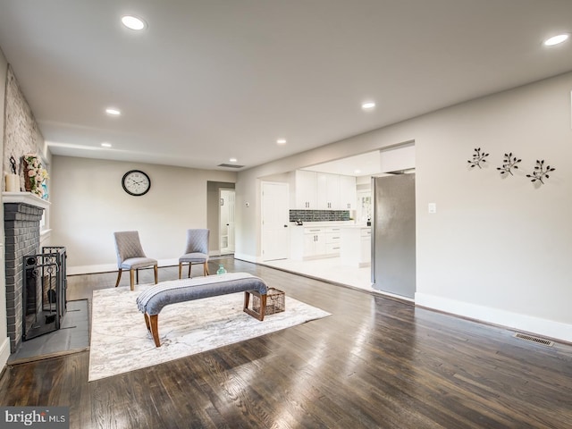 living room with wood-type flooring and a fireplace