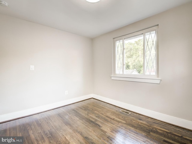 spare room with dark hardwood / wood-style flooring