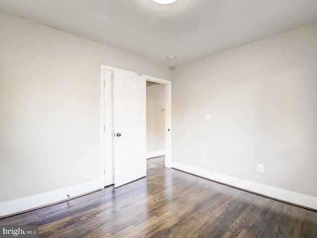 unfurnished bedroom with dark hardwood / wood-style flooring