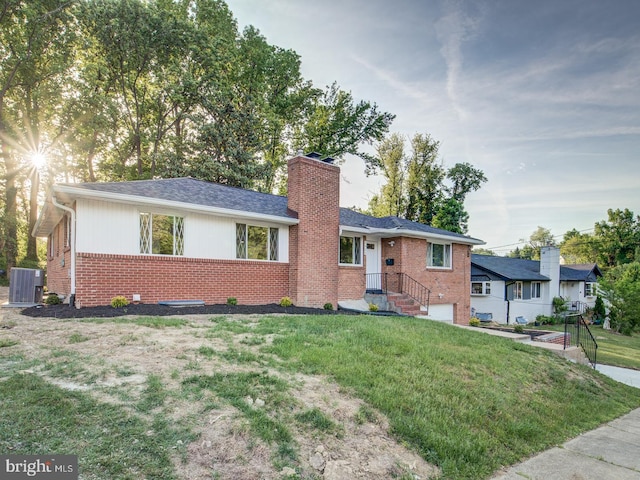 ranch-style home with central AC unit and a front yard