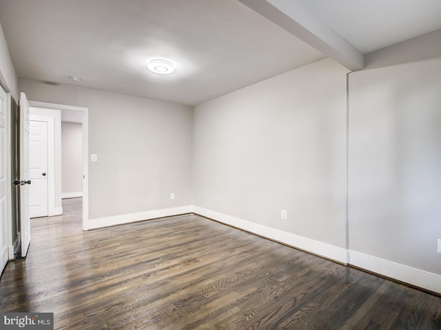 spare room featuring dark hardwood / wood-style flooring