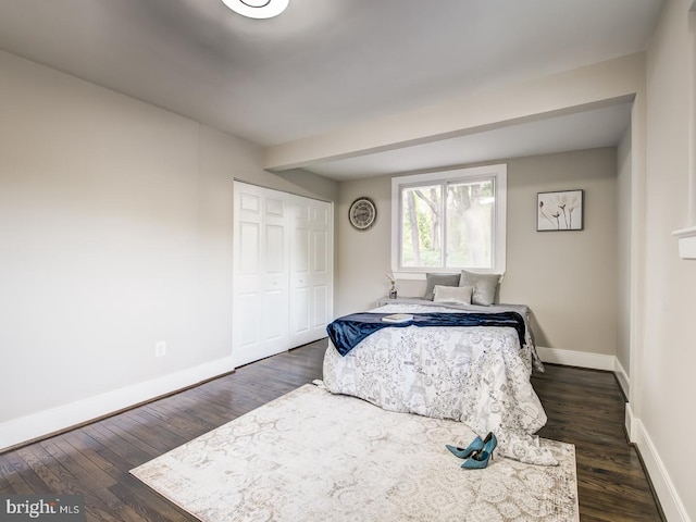 bedroom with a closet and dark hardwood / wood-style floors