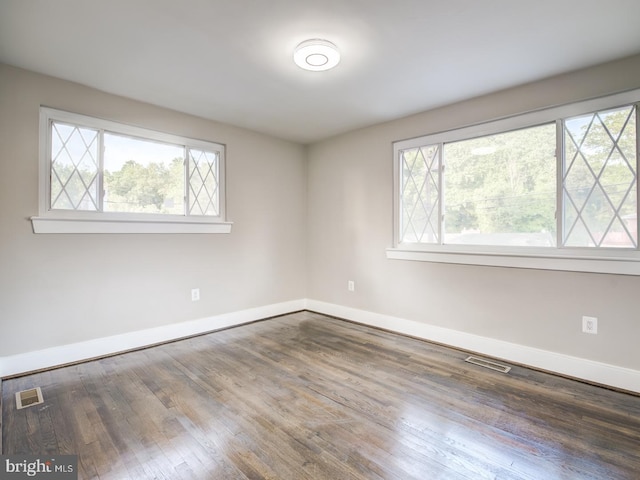 empty room with hardwood / wood-style flooring