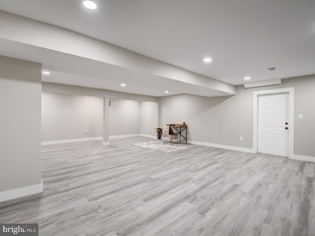 basement with light hardwood / wood-style floors