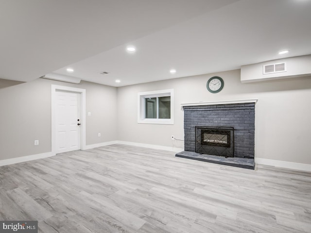 unfurnished living room with light hardwood / wood-style floors and a fireplace