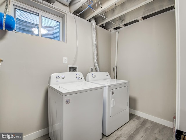 laundry area featuring light wood-type flooring and washer and dryer