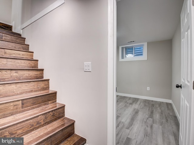 staircase featuring hardwood / wood-style floors