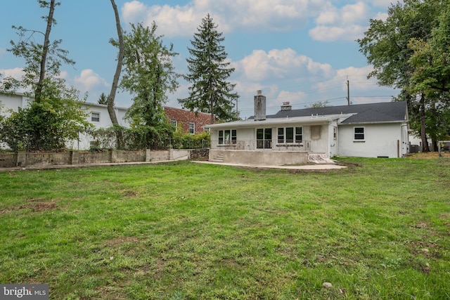 back of house featuring a yard and a patio