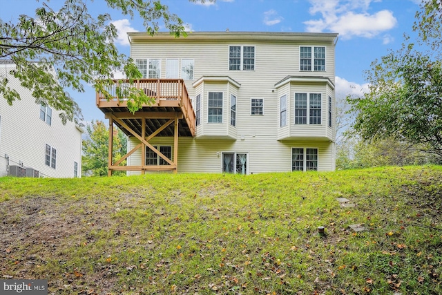 back of property with a deck and central air condition unit